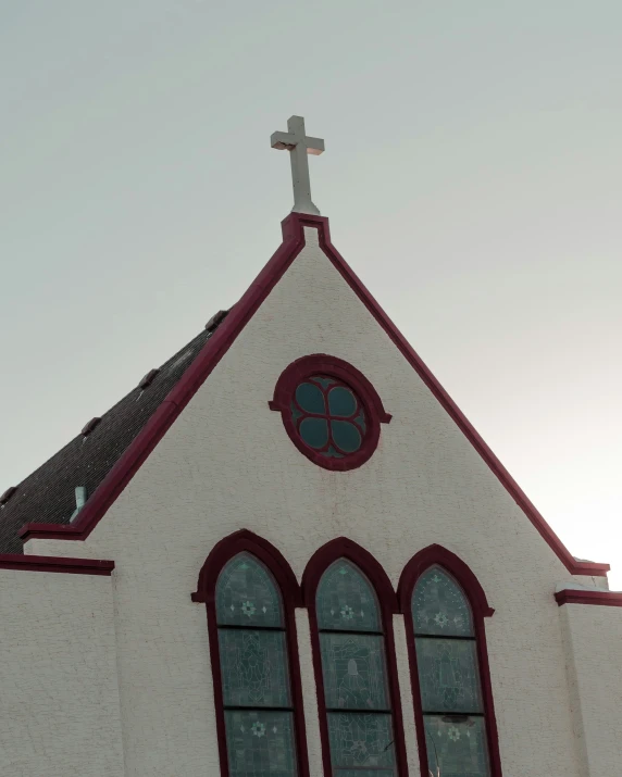 the back of a church with a cross on top of it