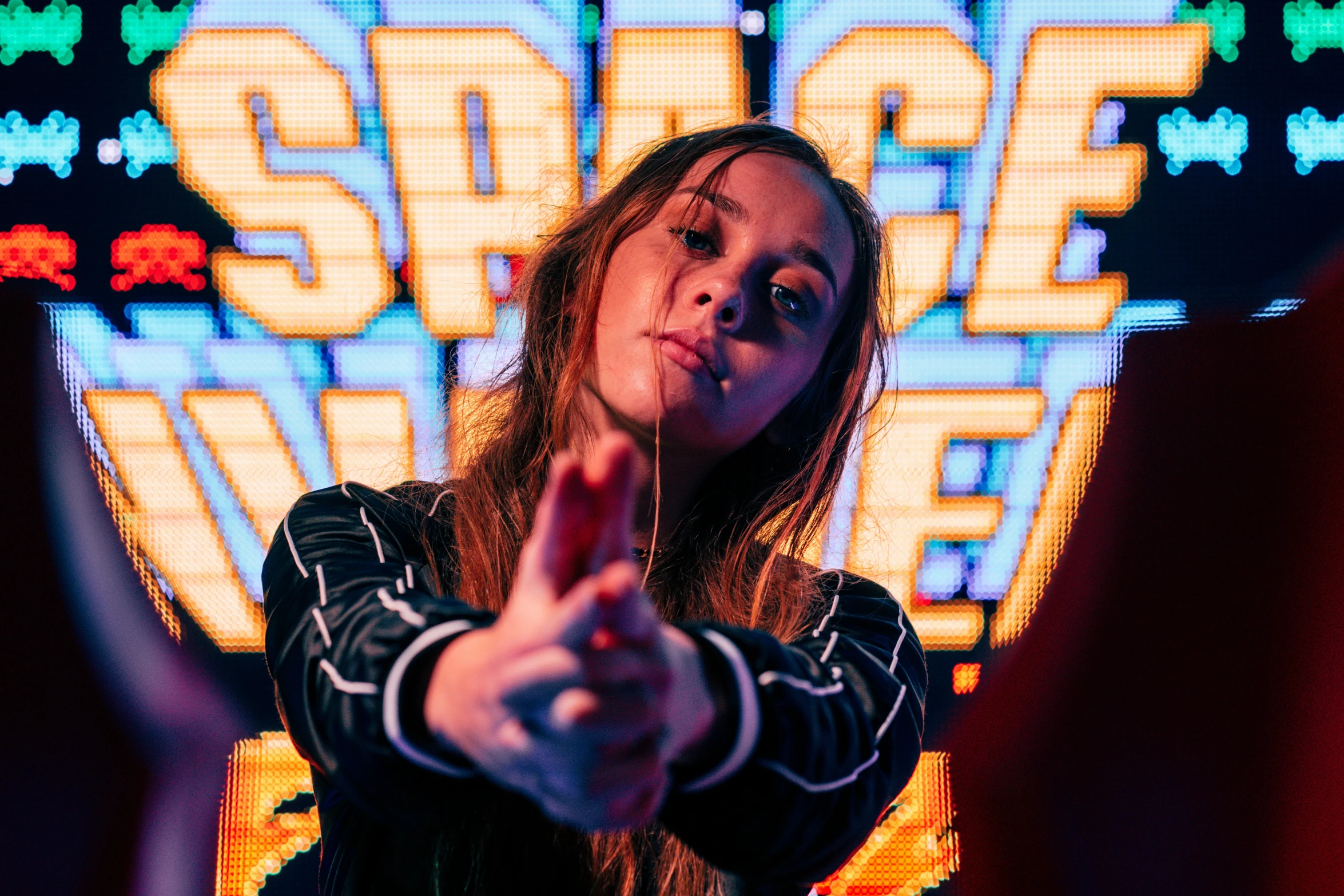 a woman points out her finger at an audience