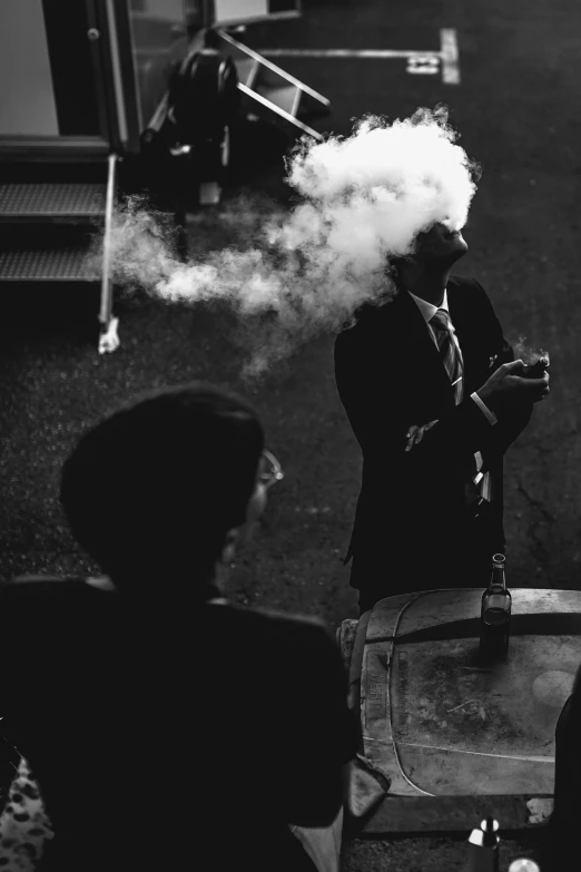 a man in a suit smoking a cigarette