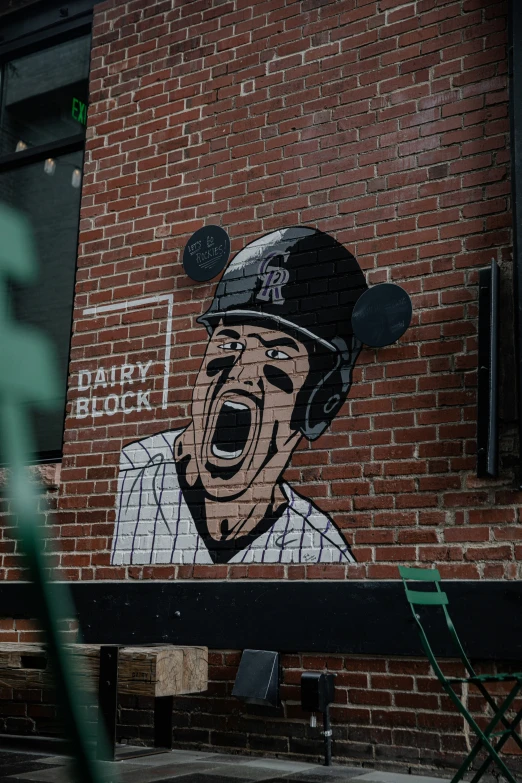 an artistic mural of a man is shown on the side of a building