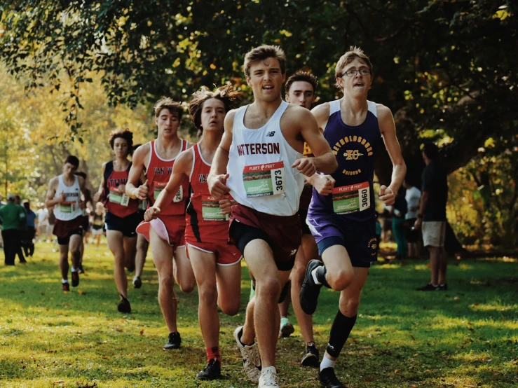 boys in uniforms on the running side of a course