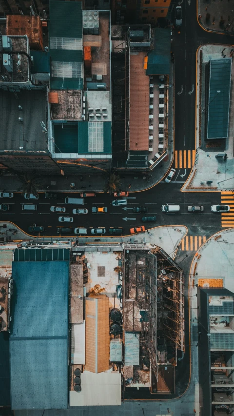 an aerial s of two streets next to buildings