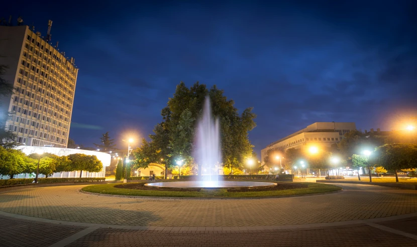 a city square filled with trees and buildings