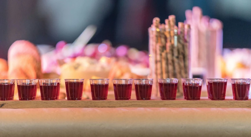 a line up of glasses that are on a table