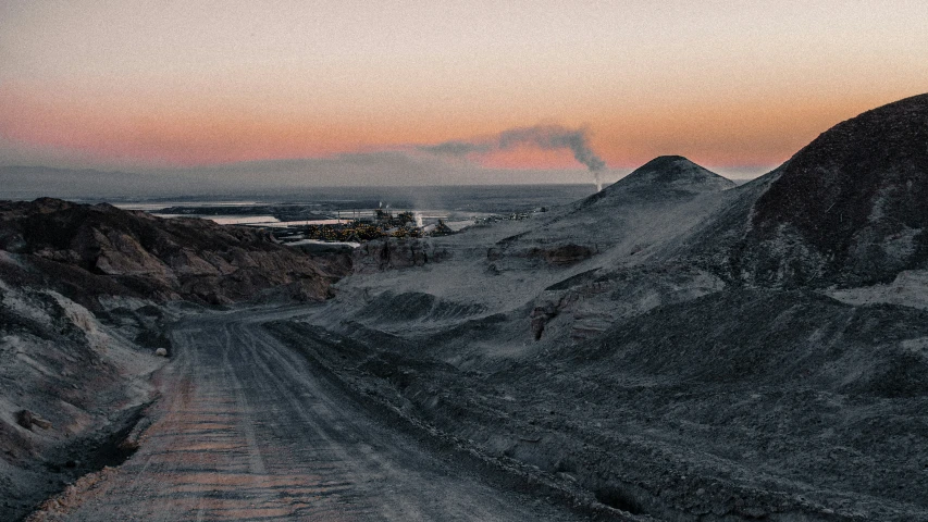 a dirt road that is in front of mountains