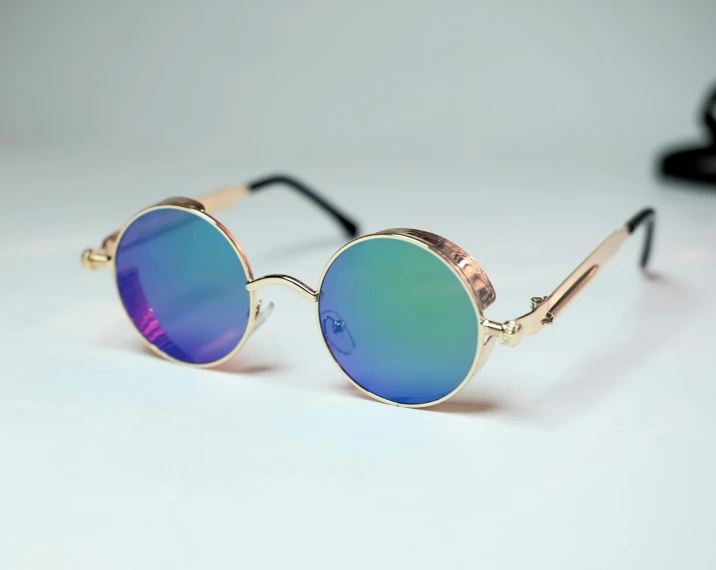 a round pair of glasses with gold rims, and blue lens