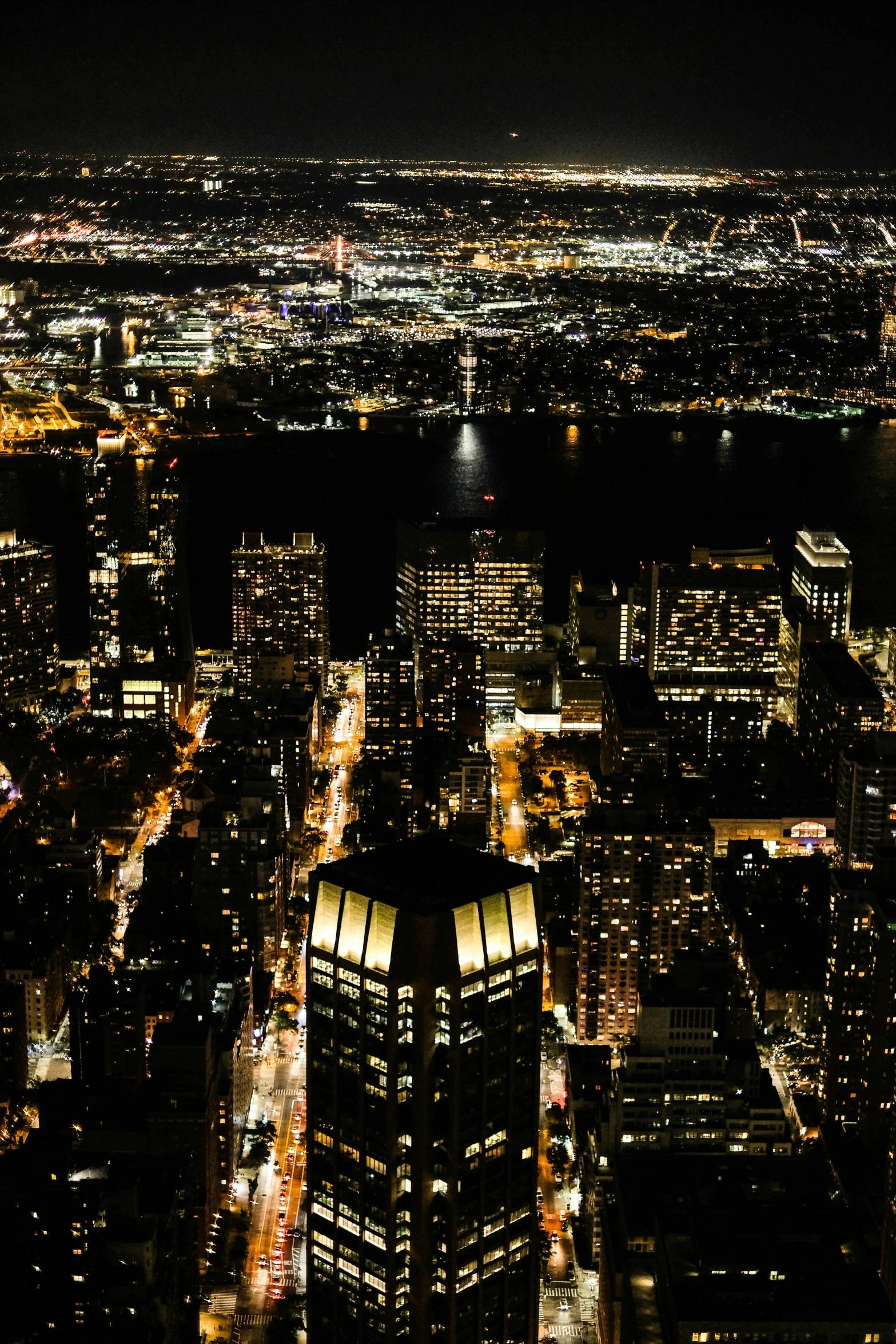 an aerial view of a city with lights at night