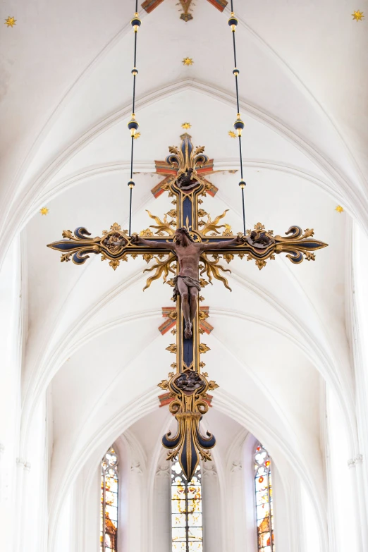 a cross in a church with stained glass