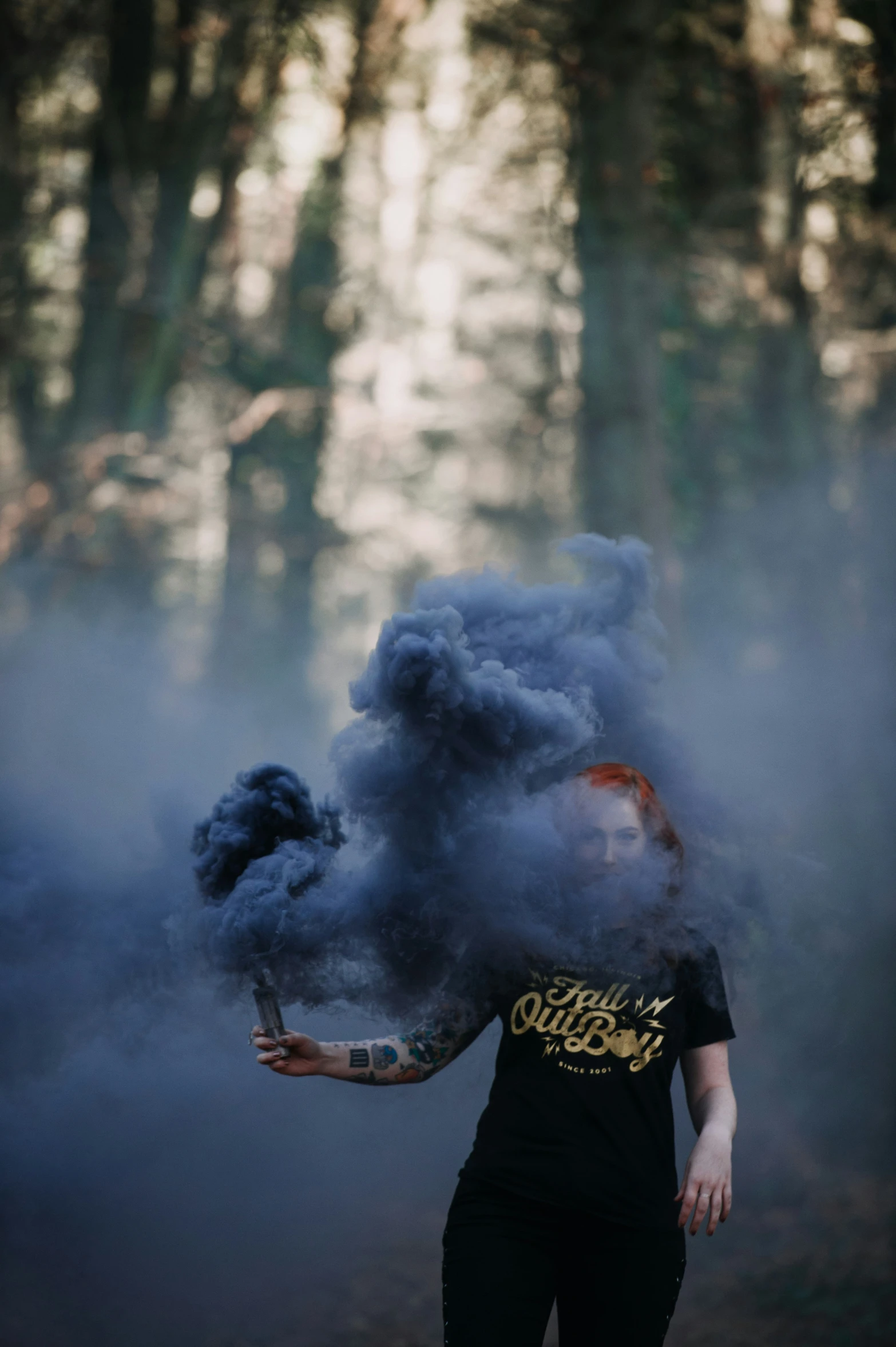 a woman is walking through smoke on her back