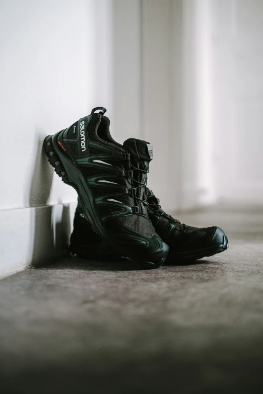 a pair of shoes in a room with a white wall