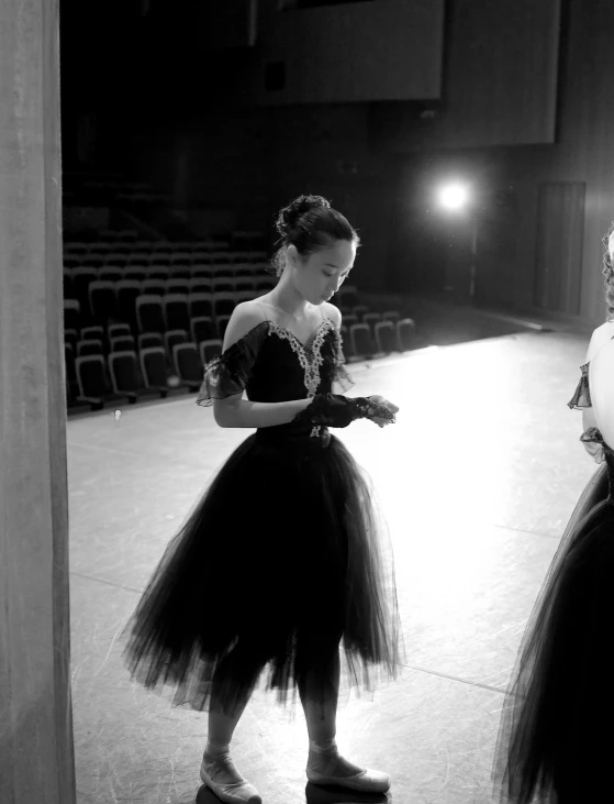 two women dressed in black and white are looking at soing