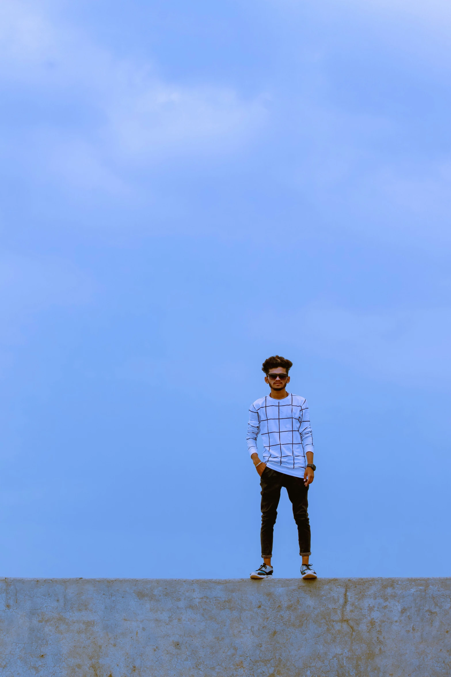 a man stands on the top of a concrete structure