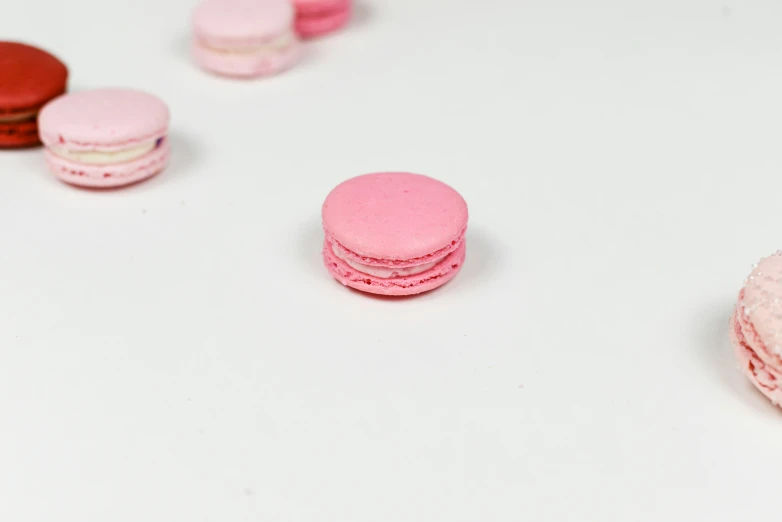 pink and white macaroni with lots of macaroons around them