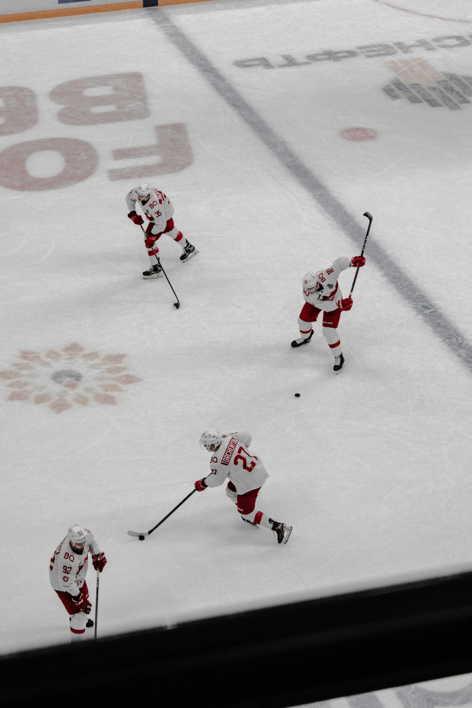 five players on the ice skating during a game