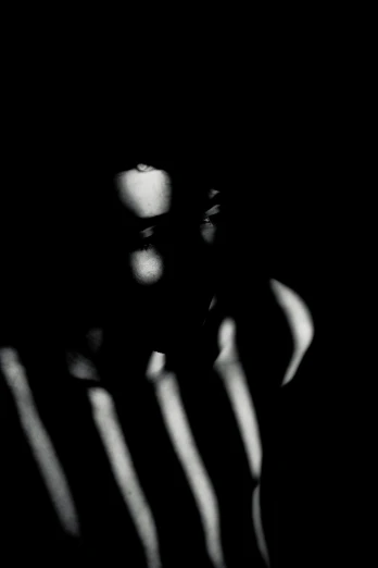 a person standing in the shadows in the dark