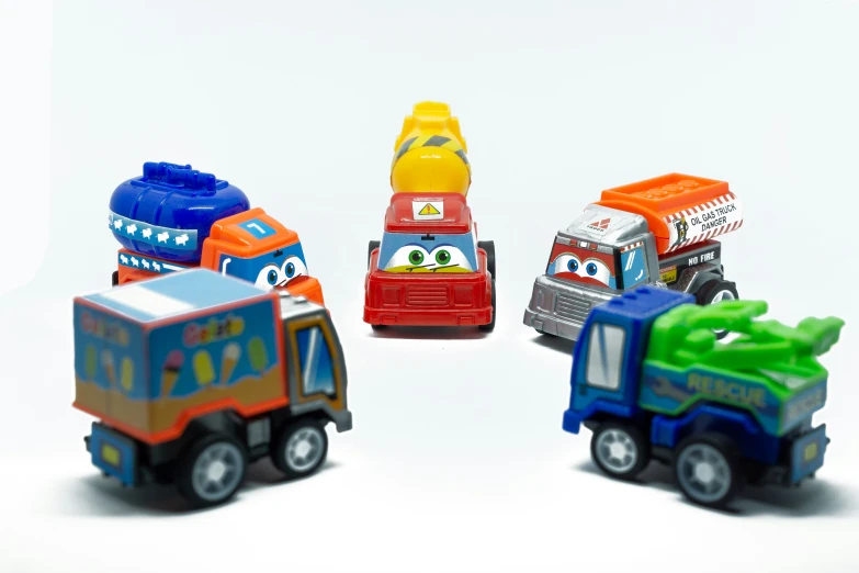 four colorful toy vehicles sitting side by side