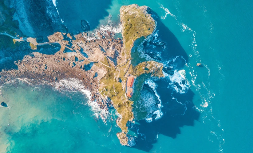 an aerial view of water and land in the ocean