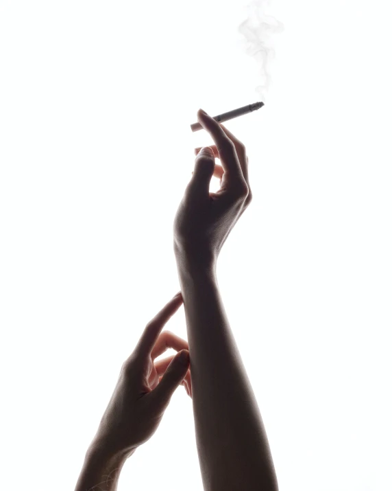 someone holds their hands out towards an electronic cigarette