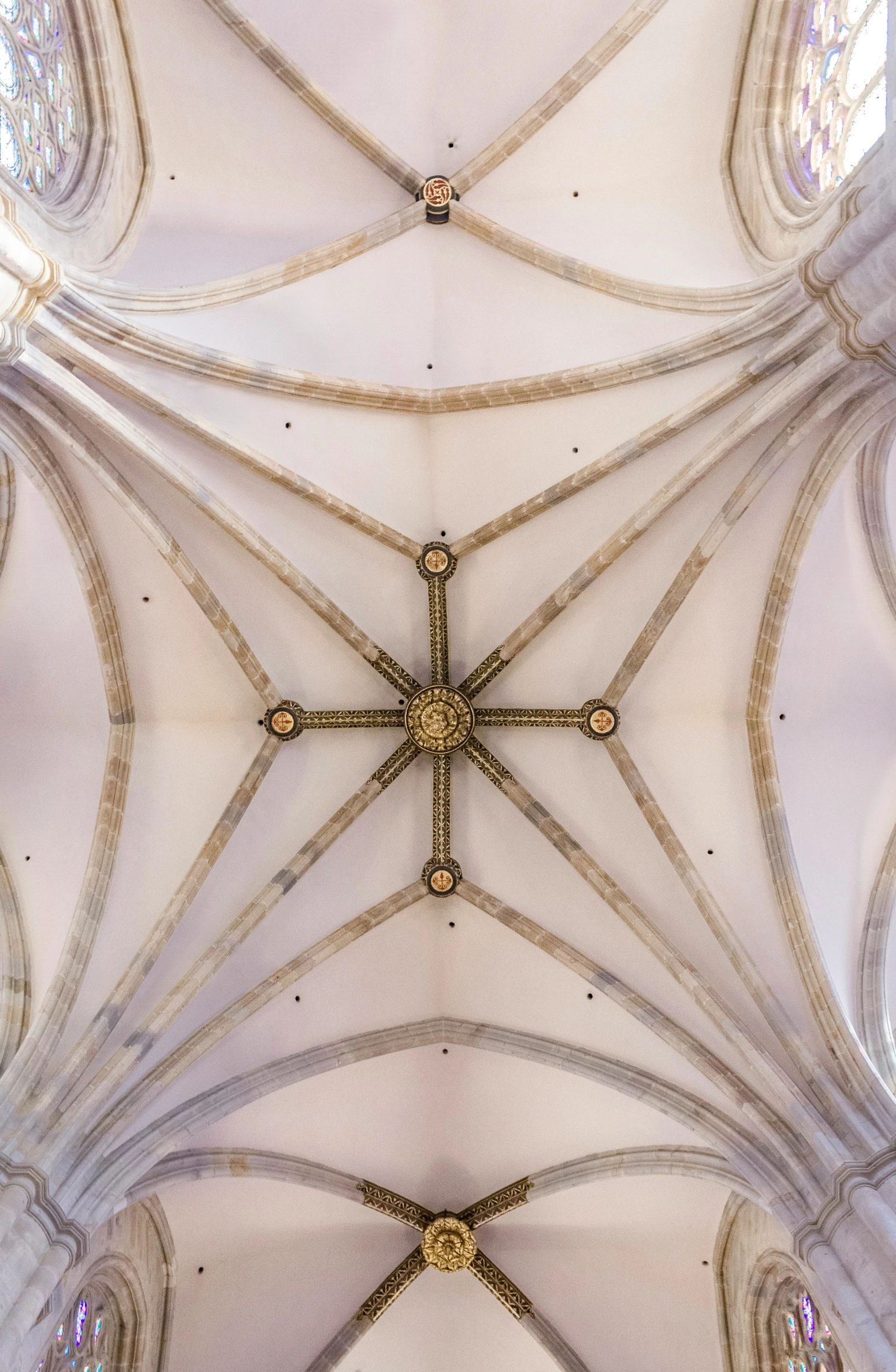 the vaulted ceilings inside of a building are adorned with arches and columns