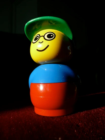 a plastic toy that is wearing a green hat