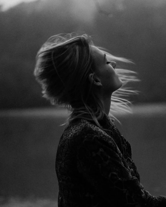 black and white pograph of a woman blowing her hair