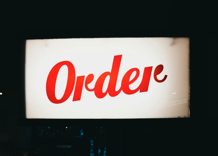 a white and red store sign with the word order