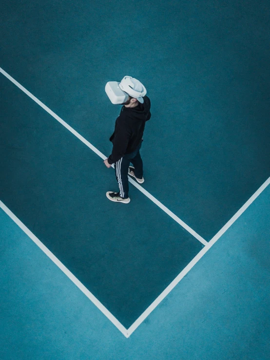 a person walking on a tennis court holding a racket