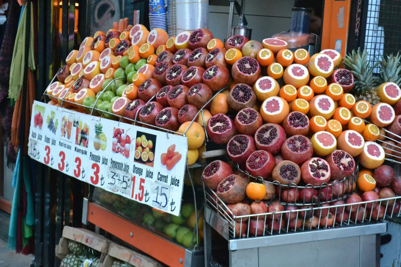 many fruits are piled high in the display