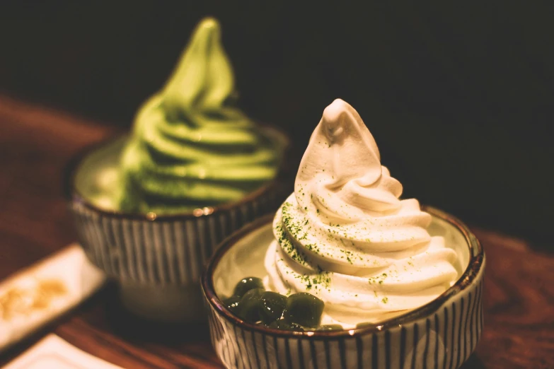 green and white desert in ceramic cups on a table