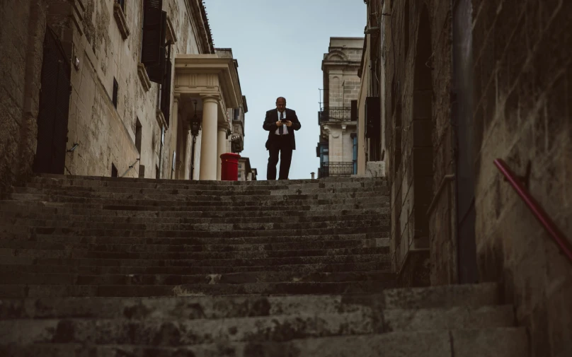 a man standing on some steps in the street