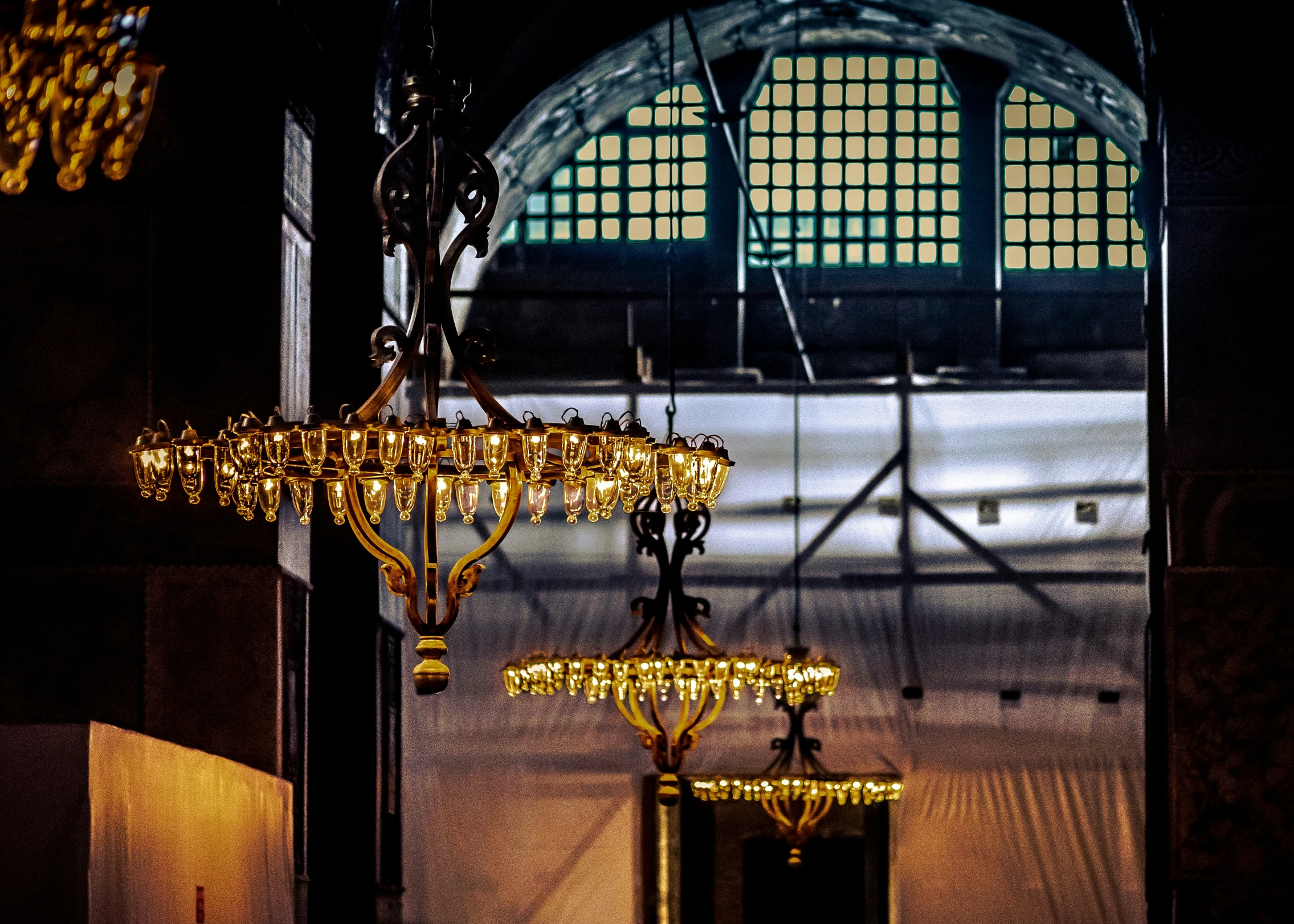 a chandelier hanging in the middle of a hallway