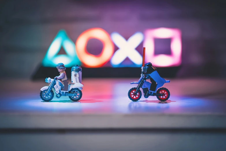 two miniature toy motorcycles are on a stage