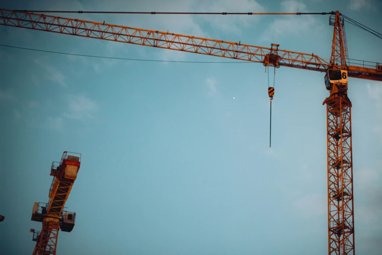 the crane is holding two cranes in its arms