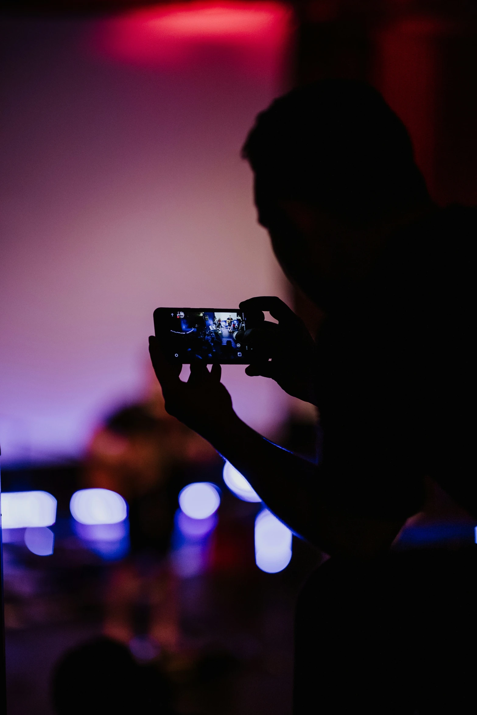 a person is holding up a phone and recording them