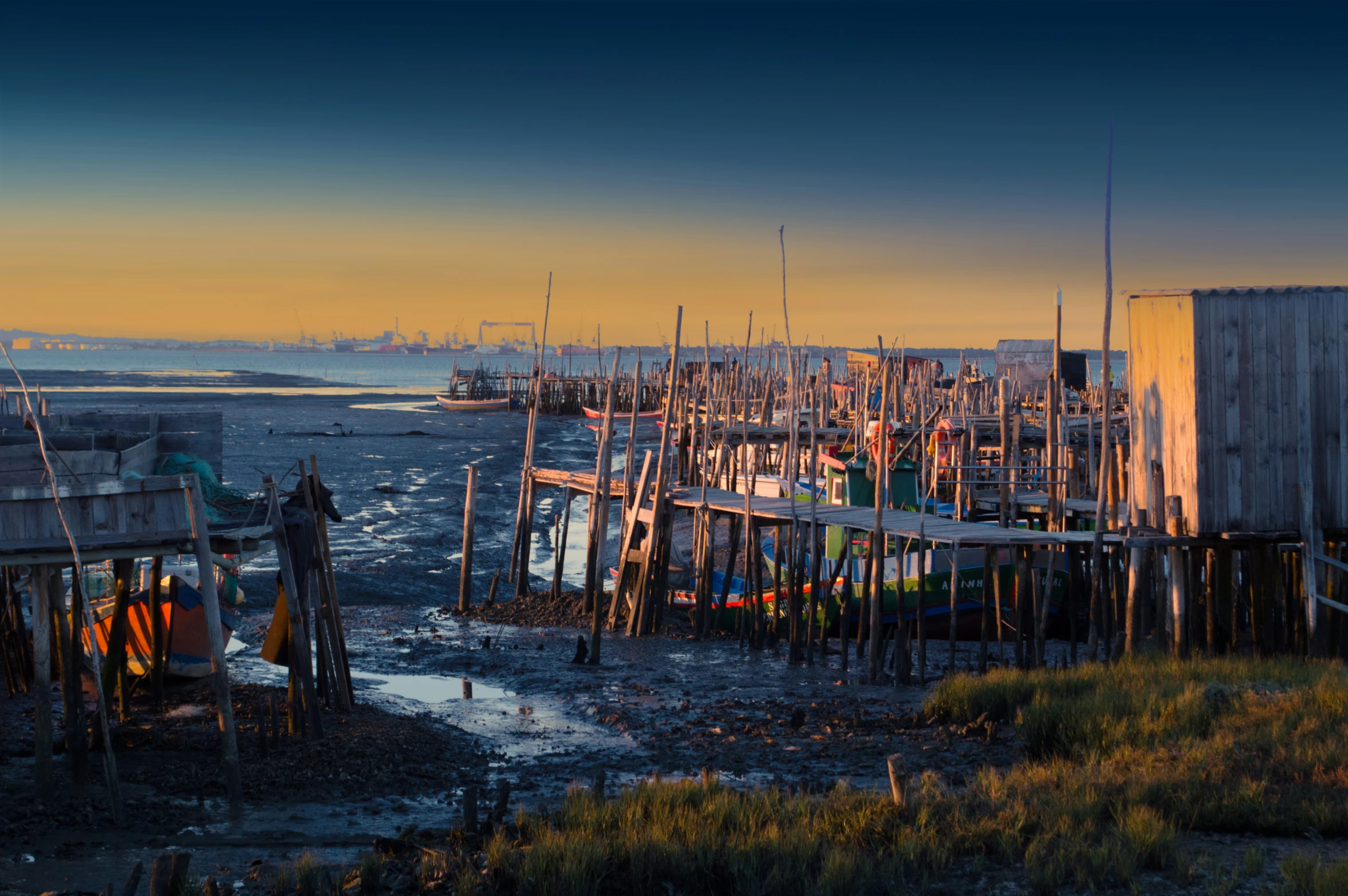 a group of small wooden structures that are out in the water