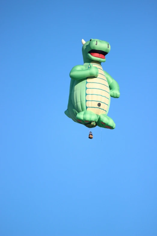 an inflated turtle is suspended by a parachute