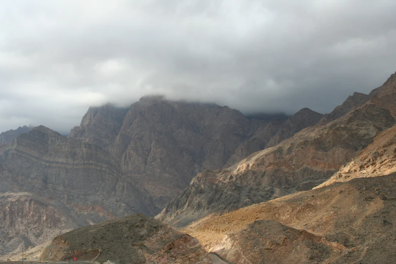 there is a cloudy sky over a mountain top