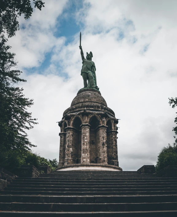 an image of a statue at the top of stairs