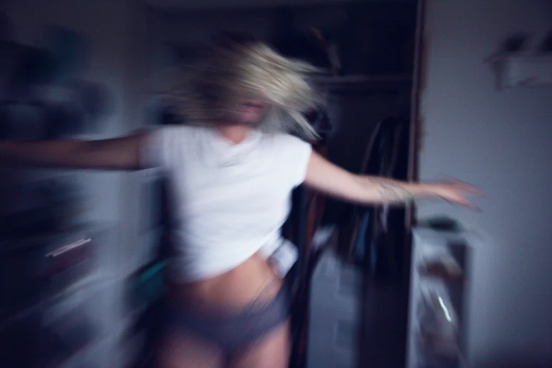 a blurry picture of a woman leaning against a door