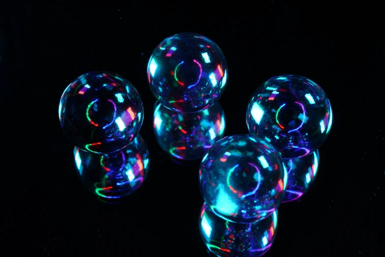 six bubbles are shown illuminated by color changing light