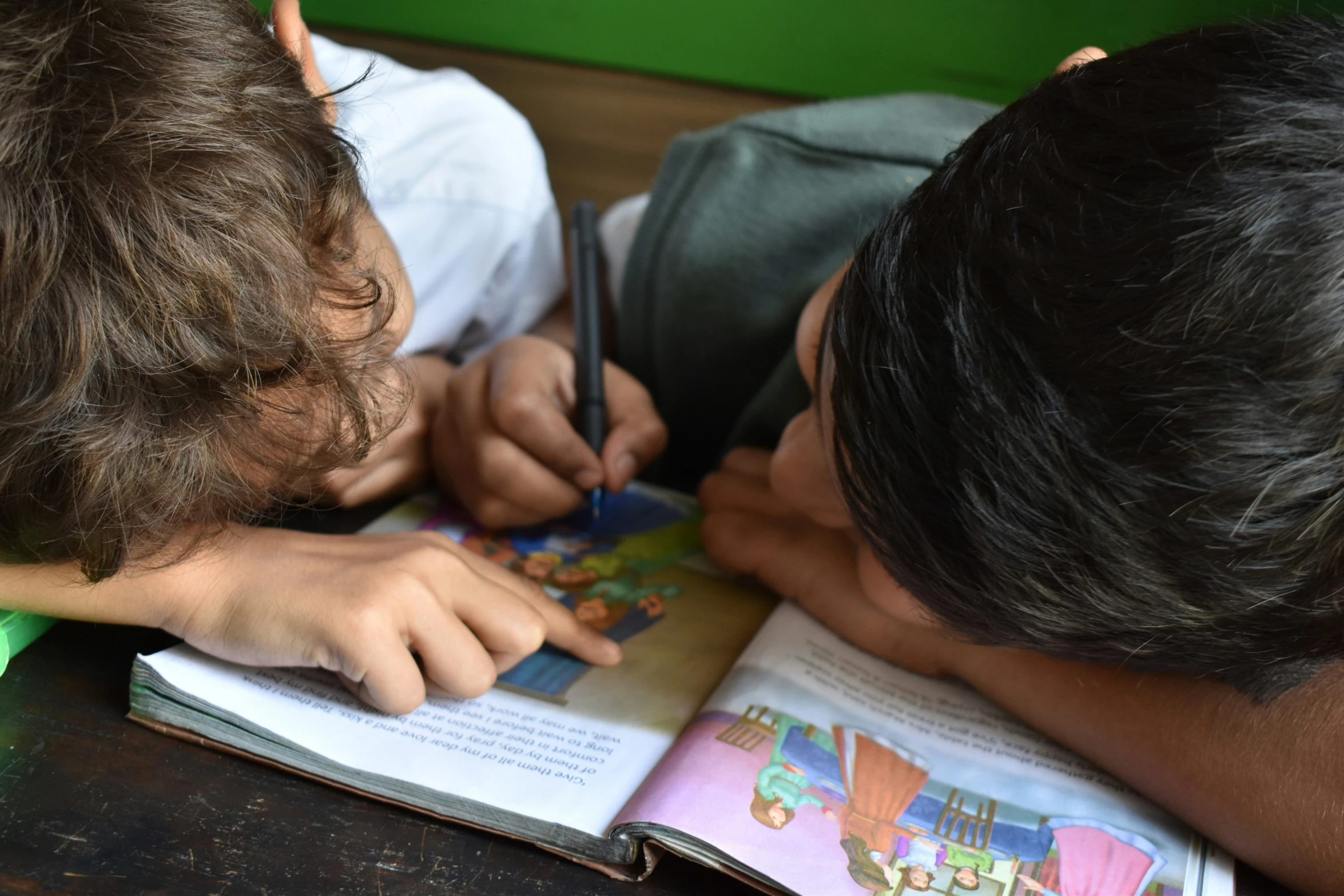 two s in school uniform doing their homework