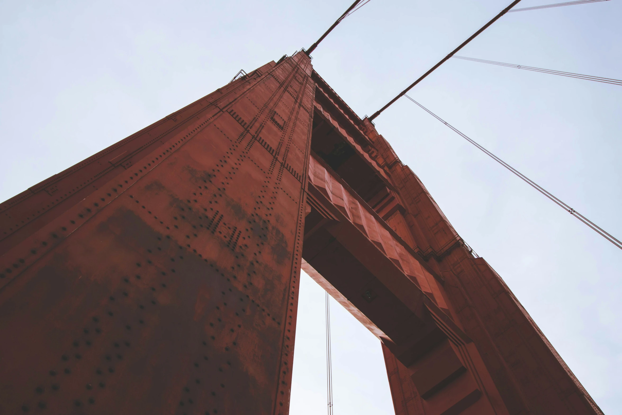 a long bridge with electrical wires and power lines above it