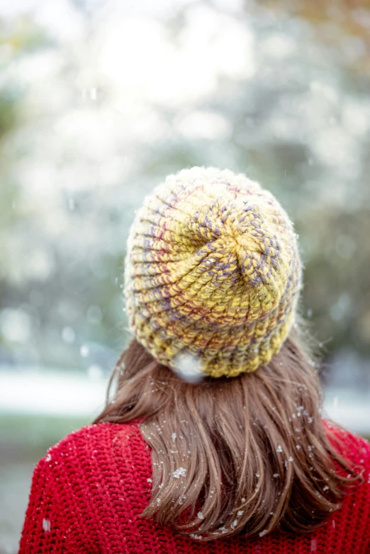 a woman in red sweater standing in snow