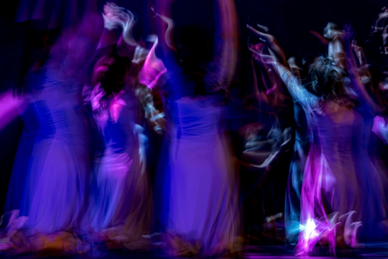 a group of people on a stage in purple