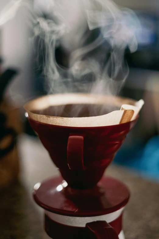 a cup with smoke in it on a plate