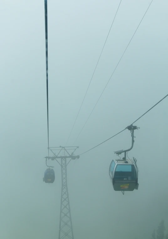 a ski lift that is going through the fog