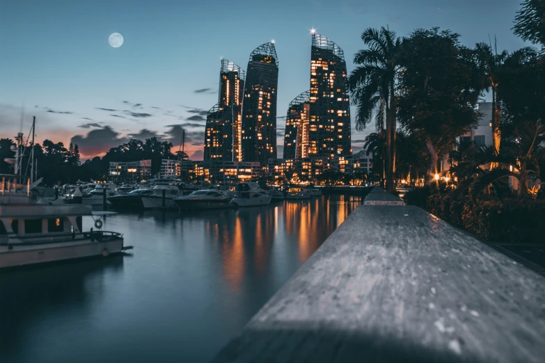 some boats in a river at night with lights on