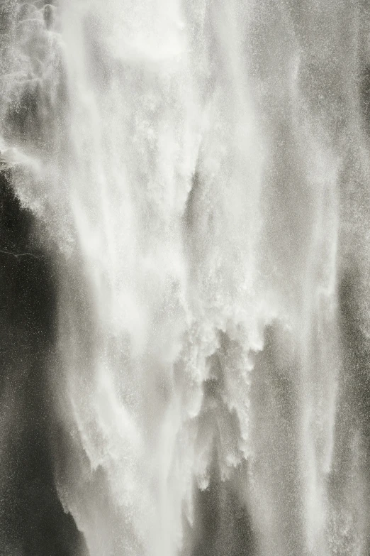 a wave hitting on a black and white image of water