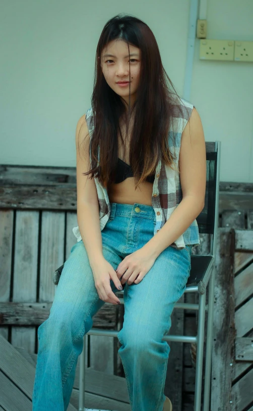 a woman sitting in a chair with her shirt on