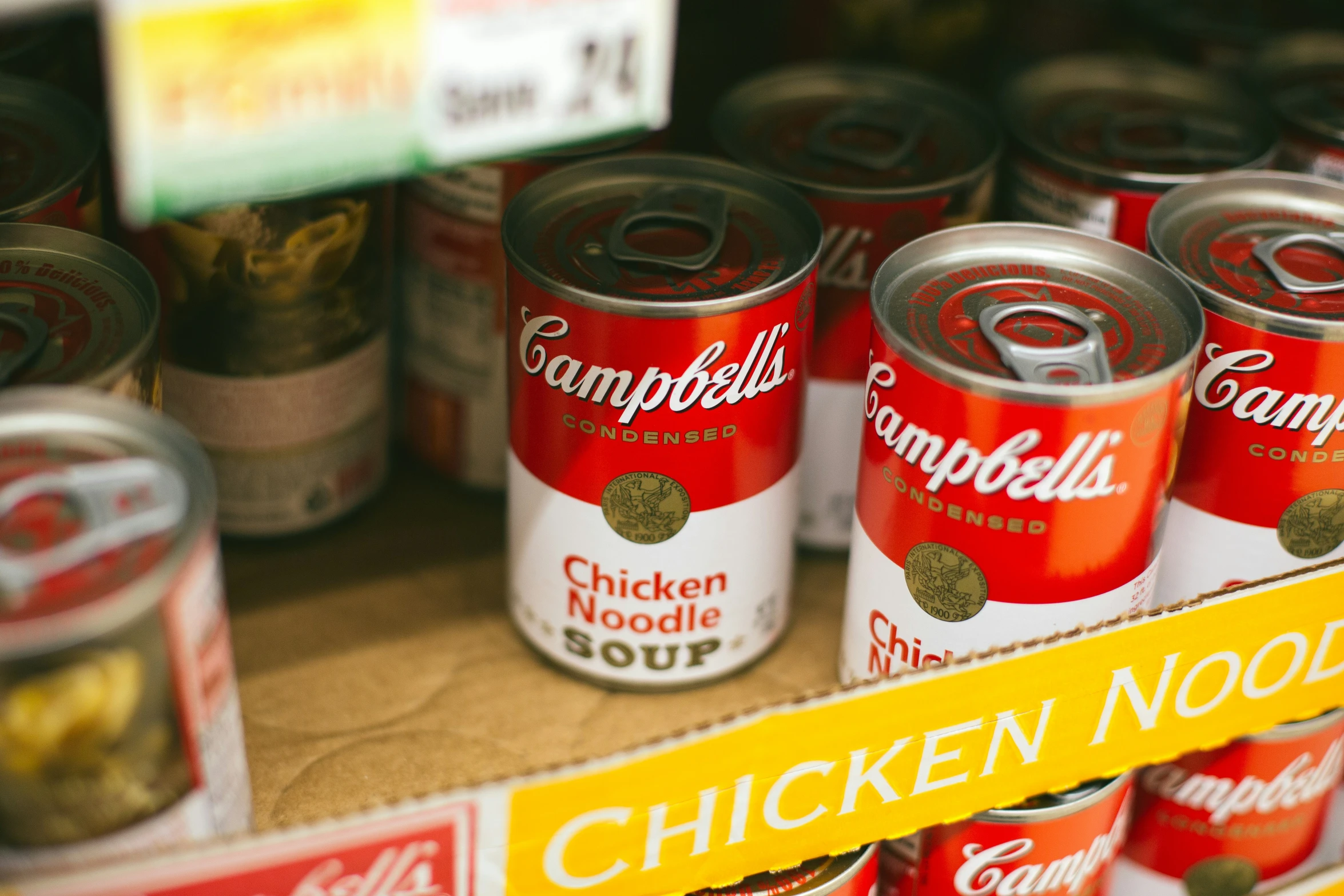 canned soup cans sit on the shelf in a grocery store